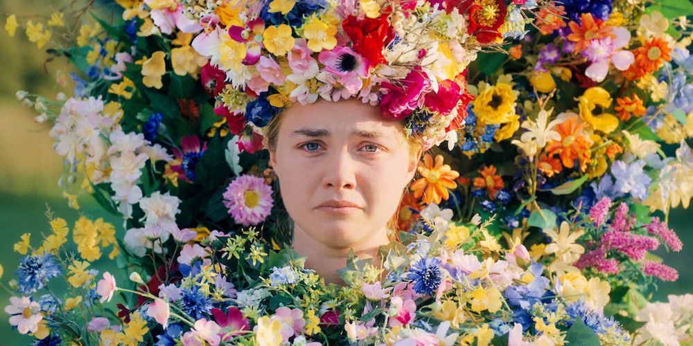 Florence Pugh in Midsommer looking sad while covered in pretty flowers 