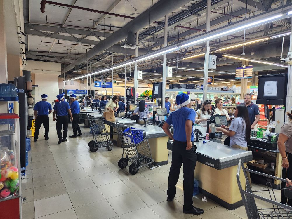 Grocery store employees all wearing Santa hats