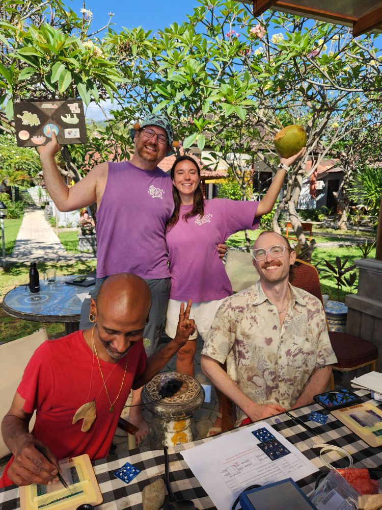 Andy and bri celebrate with shirts snd people making pcbs