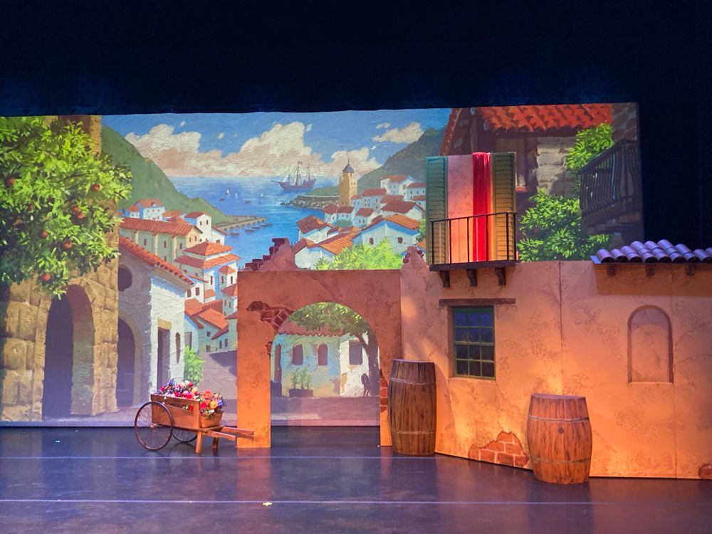 Backdrop and set on stage of Spanish seaside town for a ballet.