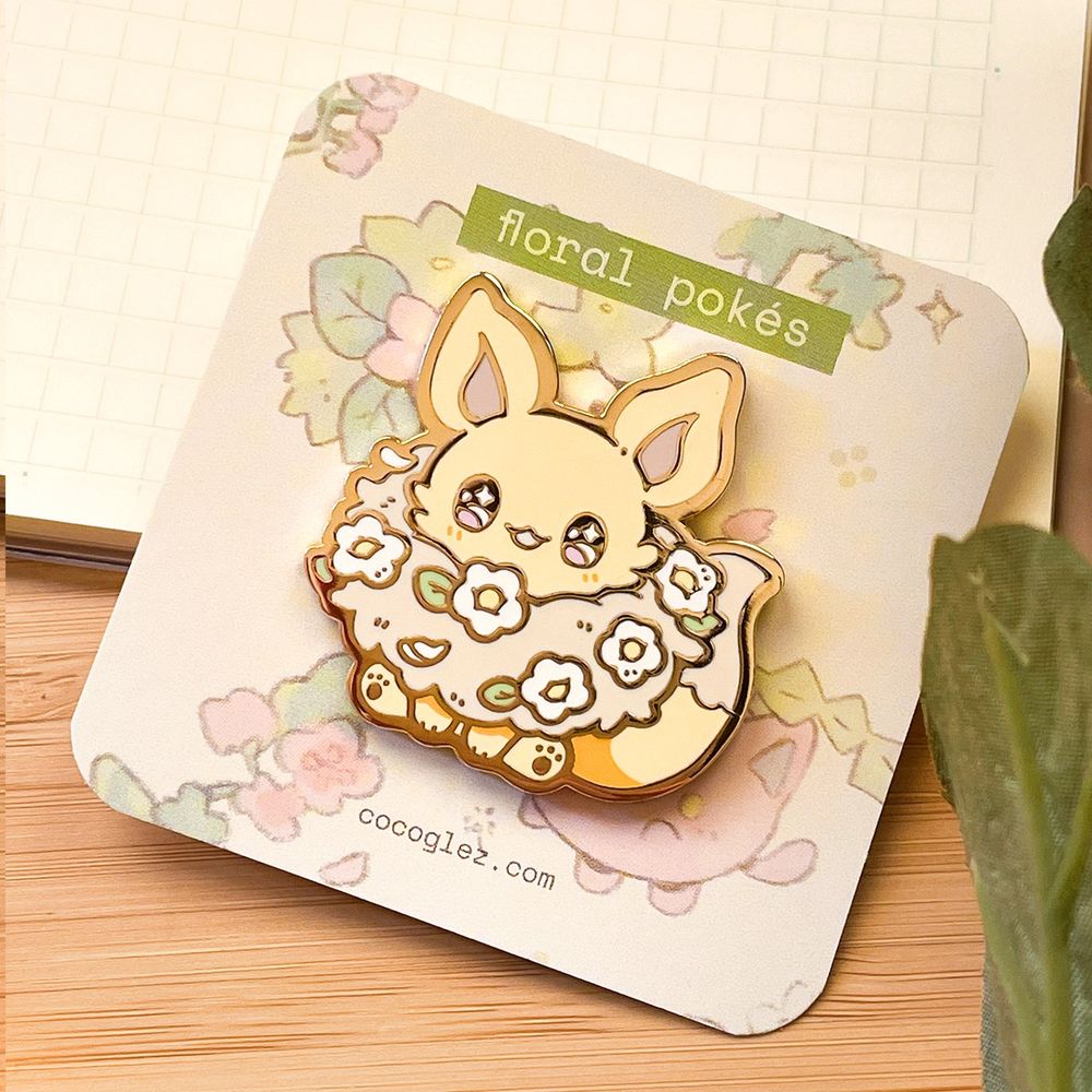 Enamel pin of Pokémon Eevee with flowers adorning his neck fur