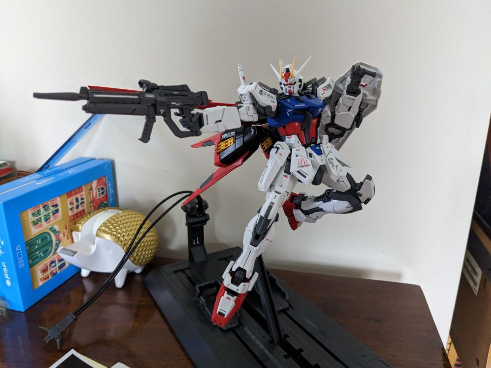 The Master Grade Alie Strike Gundam posed on a display stand.