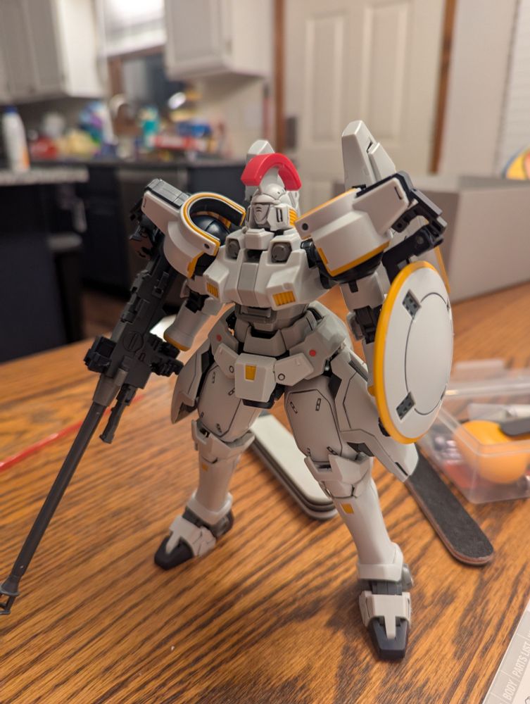 Mobile Suit Tallgeese. A white Gundam with centurion helmet, a large gun and shield. 