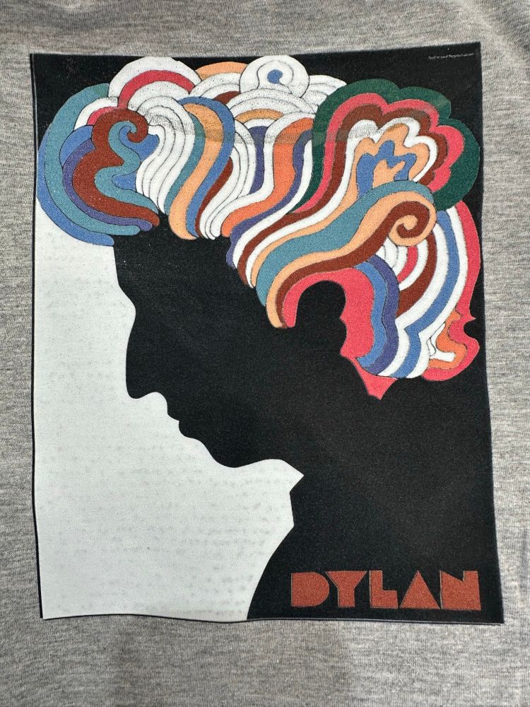 Direct to Film. White ink base layer. Would’ve been perfect if I wasn’t dumb and impatient and forgot to the thread the shirt on the heat press platen. Burned the collar texture right into the inks