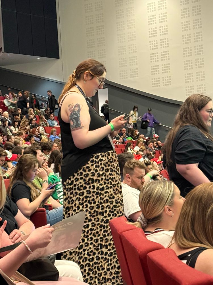 Vee at the mic, looking stunning in her leopard print skirt and black vest with her black widow tattoo out