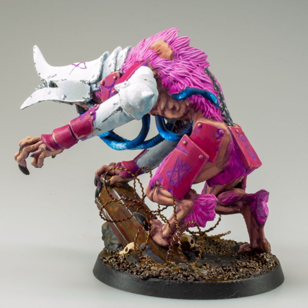 A Hellish Abomination with Blue cables pumping unto long, gangled limbs. White and Hot Pink armor is hammered into its form, black claws hanging above a muddy, desecrated battlefield.

It also has bright pink fur.