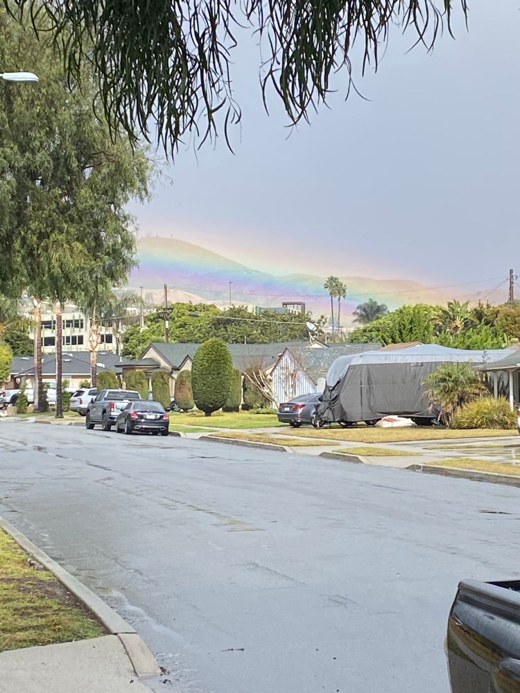 Big rainbow over the hills during light rain