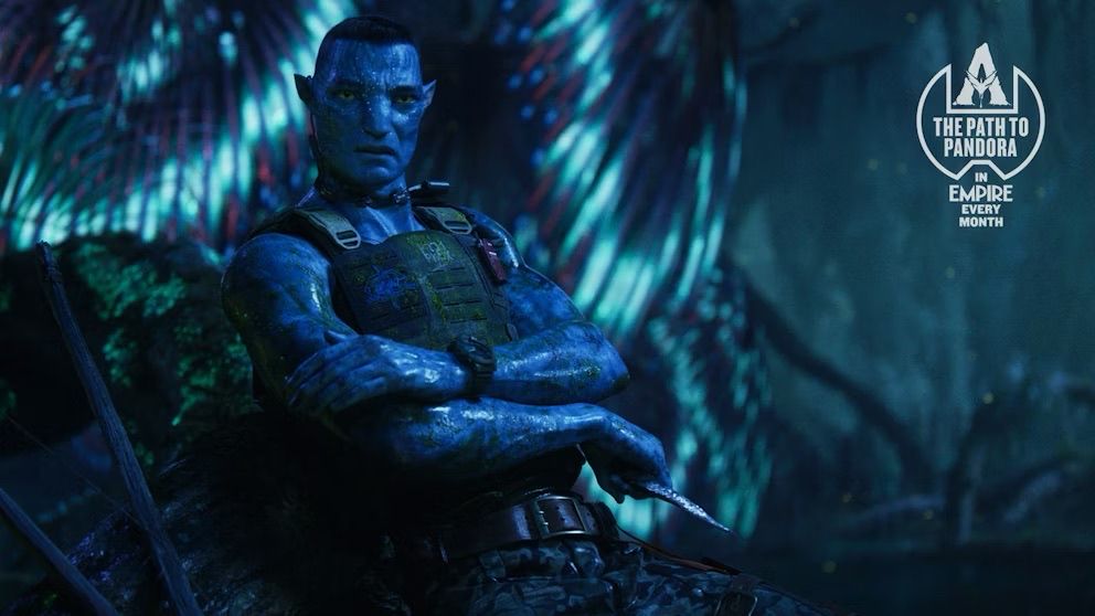 Recom Quaritch leaning on a rock, crossing his arms,holding a knife and covered in moss. Night time in the jungle.