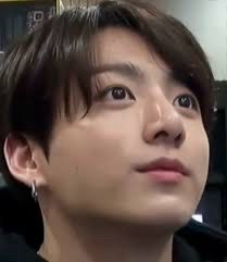 a photo of Jungkook, who’s looking up at something off camera in a way that emphasises his big brown eyes