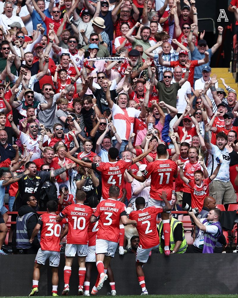 Harvey Knibbs of Charlton Athletic celebrates scoring his team's first goal with fans and teammates during the Sky Bet Championship match between Charlton Athletic and Watford at The Valley on August 09, 2025 in London, England.