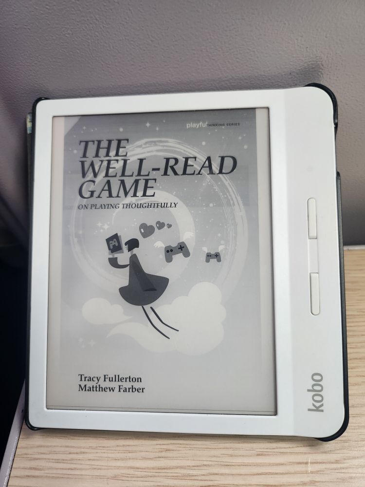 An e-reader displaying the book cover for "The Well-Read Game: On Playing Thoughtfully." The cover shows a stylized animated character floating in the clouds reading a book.