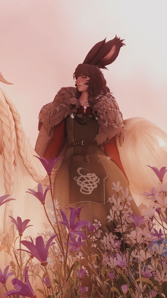 sjol sitting side-saddle on argos in a flowery field against a pale pink sky.