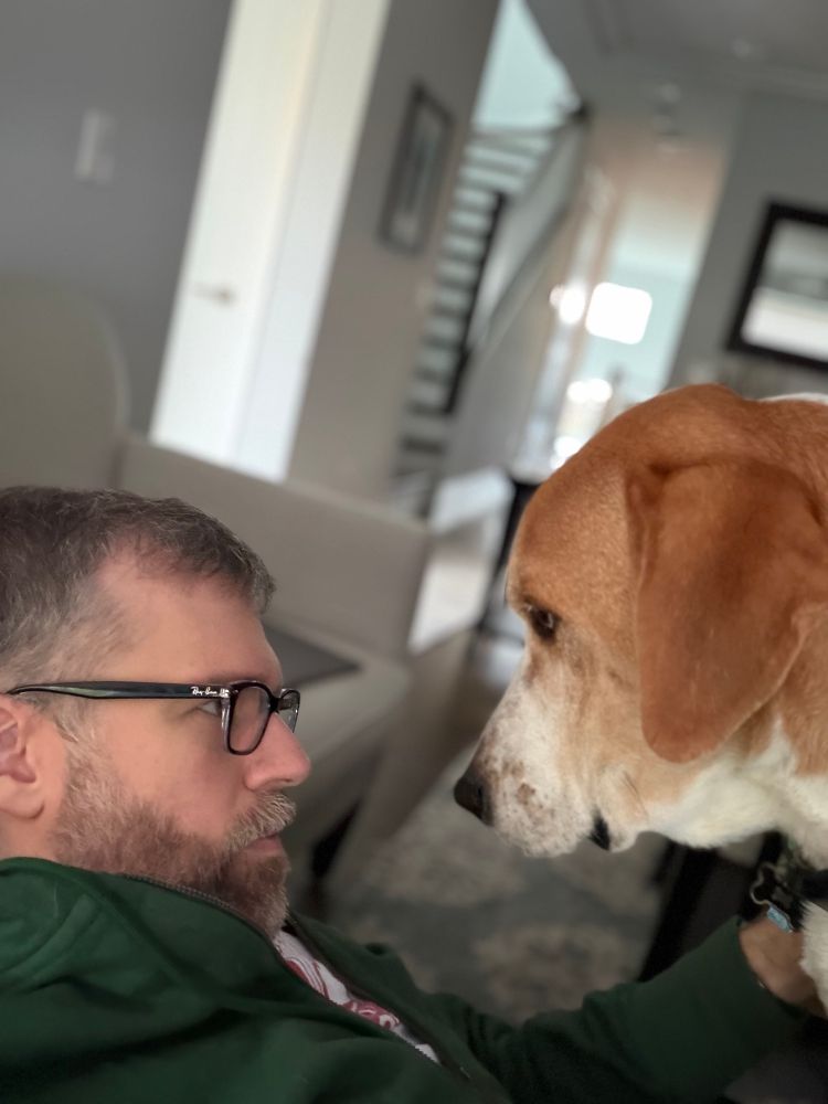 Huckleberry, a golden and white hound mix, is more or less nose to nose with me, a bespectacled white dude, demanding his dinner ASAP