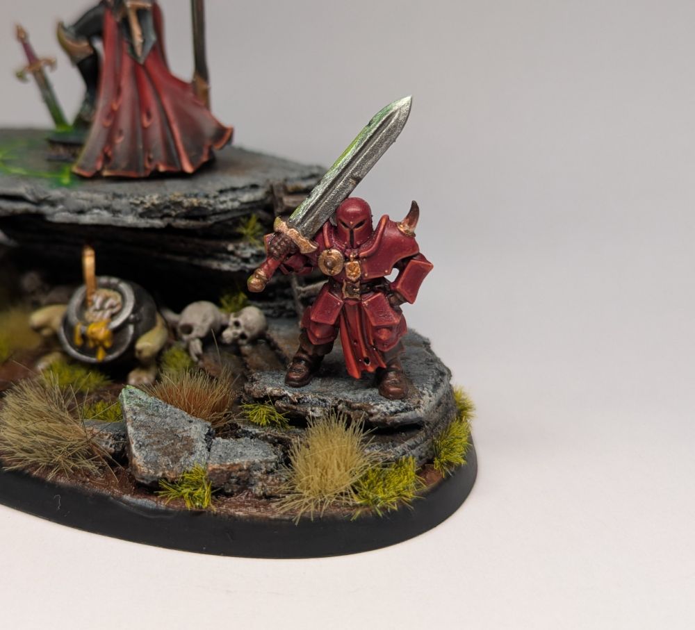An enigmatic armoured chaos minion holding a massive sword