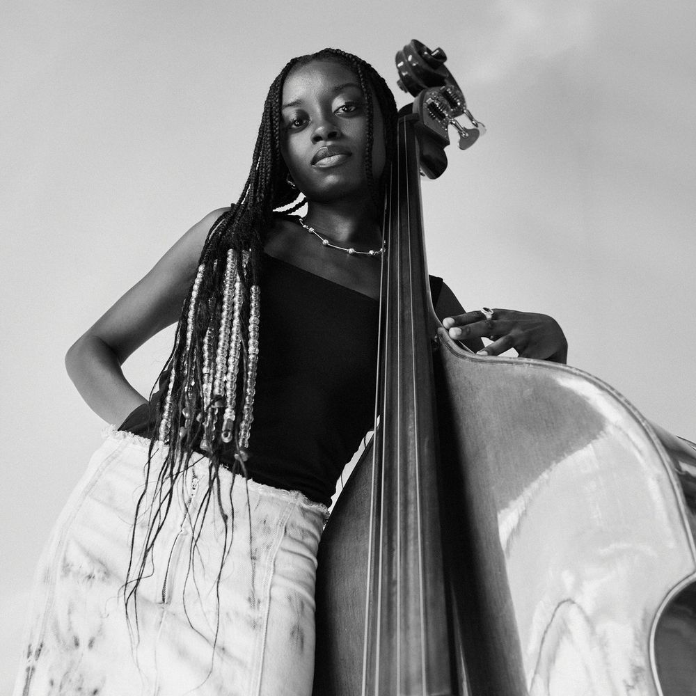 Bassist/vocalist Amy Gadiaga leaning on her double bass.