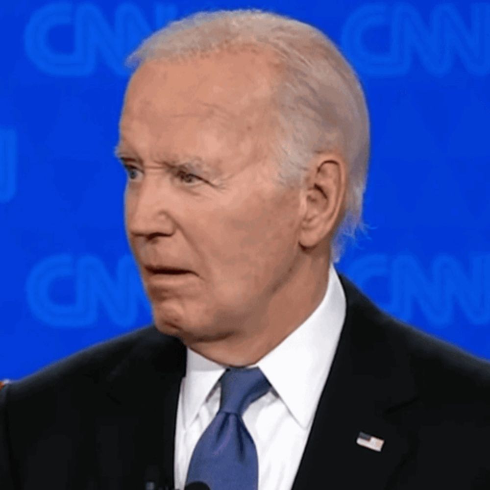 a man in a suit and tie is standing in front of a cnn background