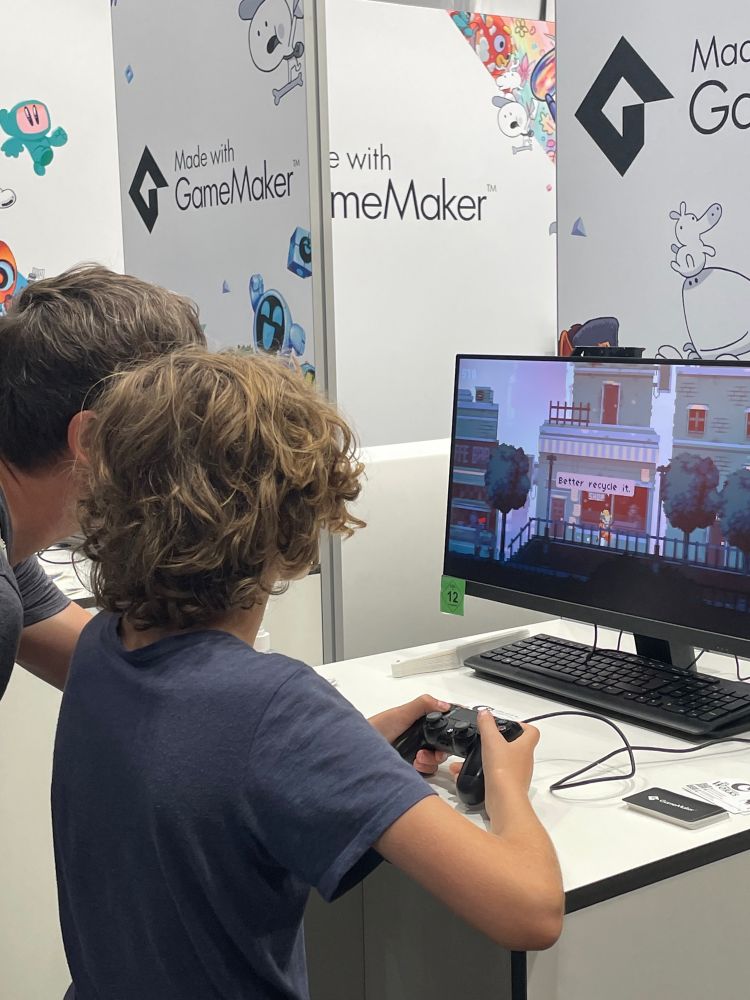 People playing A Day at GameMaker’s Gamescom booth
