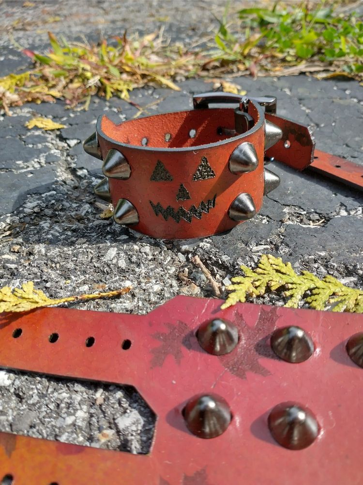 leather cuffs with jack-o-lanterns on them.