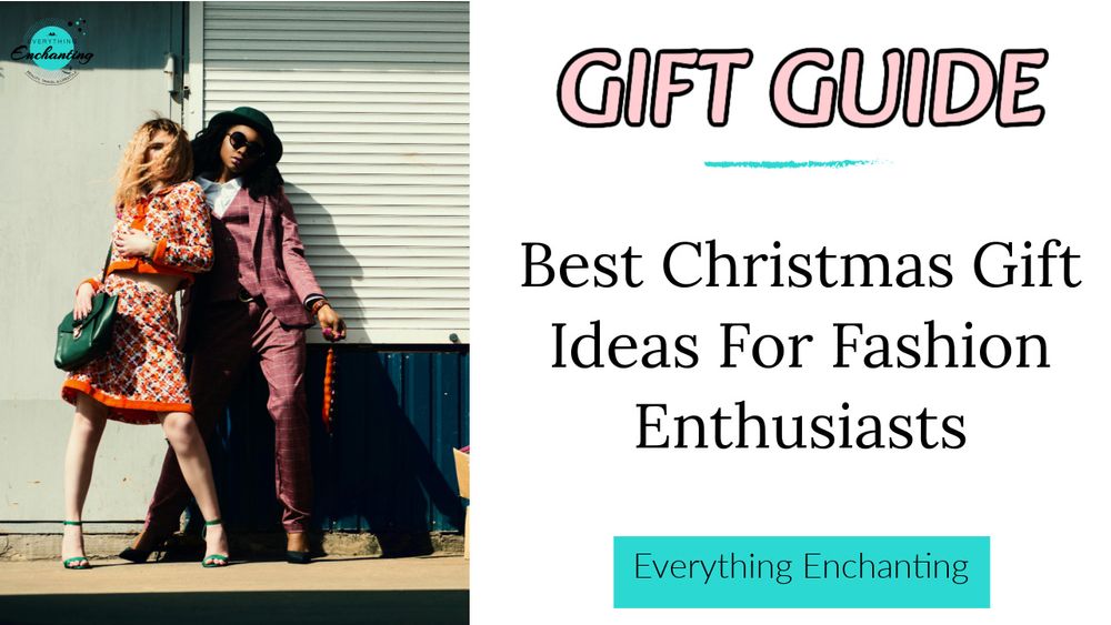 Two stylishly dressed women posing against a light wall next to a dark wall. The woman on the left has red hair and is wearing a matching orange and cream patterned skirt and cropped jacket set with green heels and a dark green handbag. The woman on the right has dark hair, is wearing a dark fedora hat, a patterned mauve suit, and dark sunglasses. Large text overlay reads "GIFT GUIDE Best Christmas Gift Ideas For Fashion Enthusiasts" with the blog name "Everything Enchanting" in a small logo and a banner.