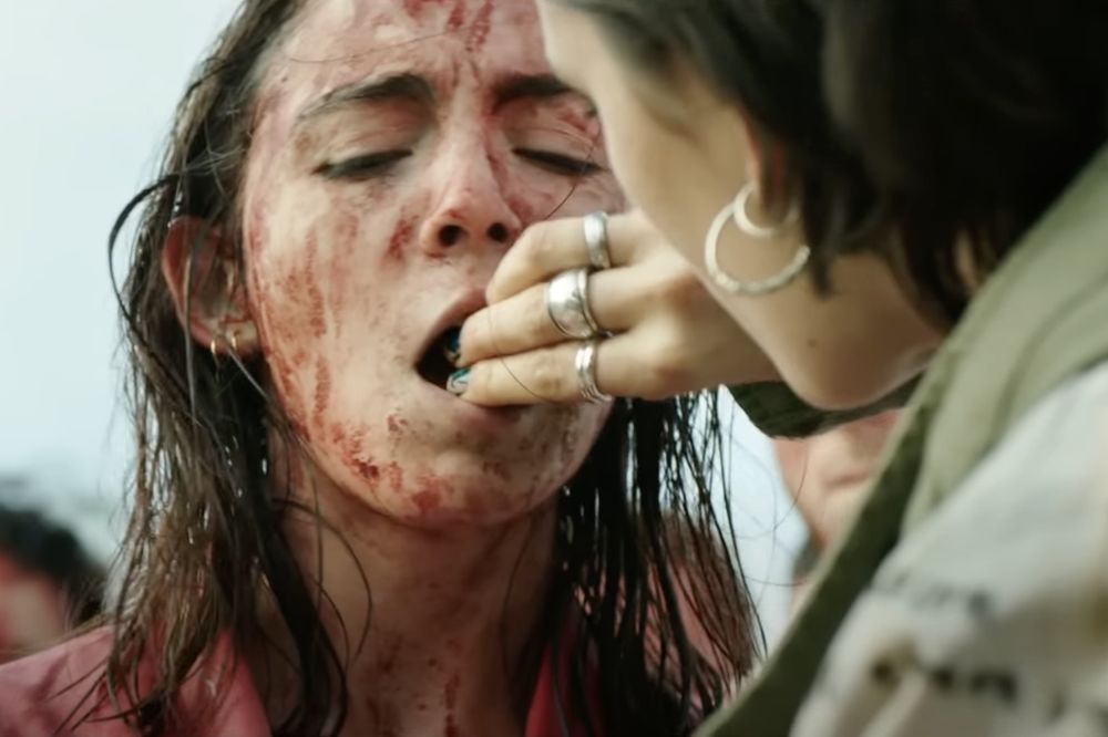 Justine, covered in drying blood, is hand-fed raw rabbit kidney by Alexia What a great older sister.