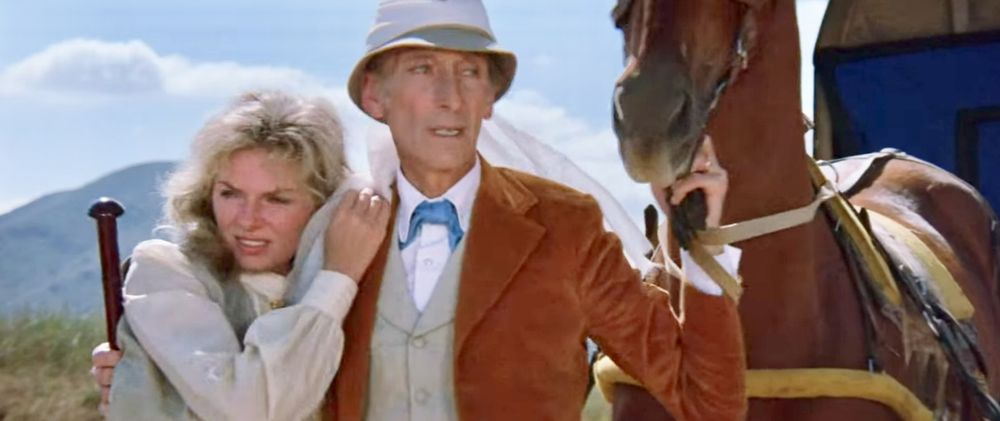 Peter Cushing as Van Helsing comforts a distraught Julie Ege as Vanessa Buren and a horse in the midst of (off-screen) kung fu action.