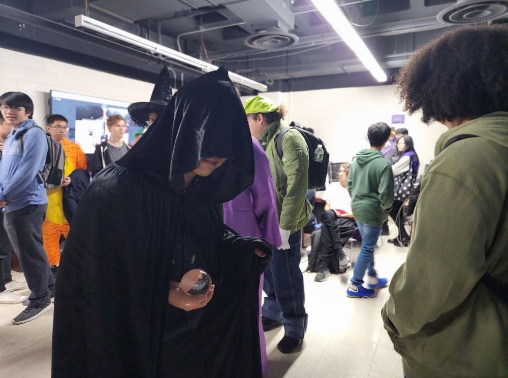 Cloaked student holding a crystal ball