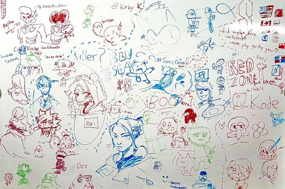 Collage of video game & anime drawings on whiteboard