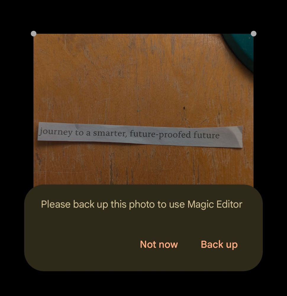 photo of paper strip printed with "journey to a smarter, future-proofed future" and an error message saying "Please back up this photo to use Magic Editor"