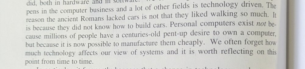 Photo of a textbook page reads "the reason the ancient Romans lacked cars is not that they liked walking so much. It is because they did not know how to build cars. Personal computers exist not because millions of people have a centuries-old pent-up desire to own a computer, but because it is now possible to manufacture them cheaply. We often forget how much technology affects our view of systems and it is worth reflecting on this point from time to time.