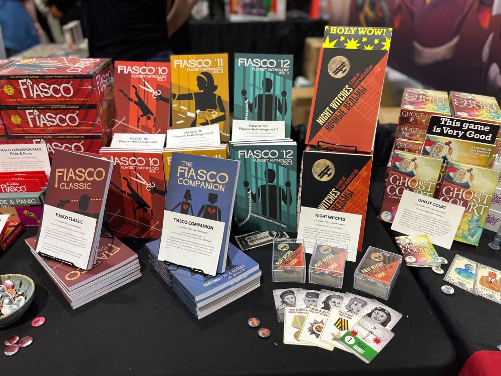 A convention table is shown with roleplaying games arranged artfully.