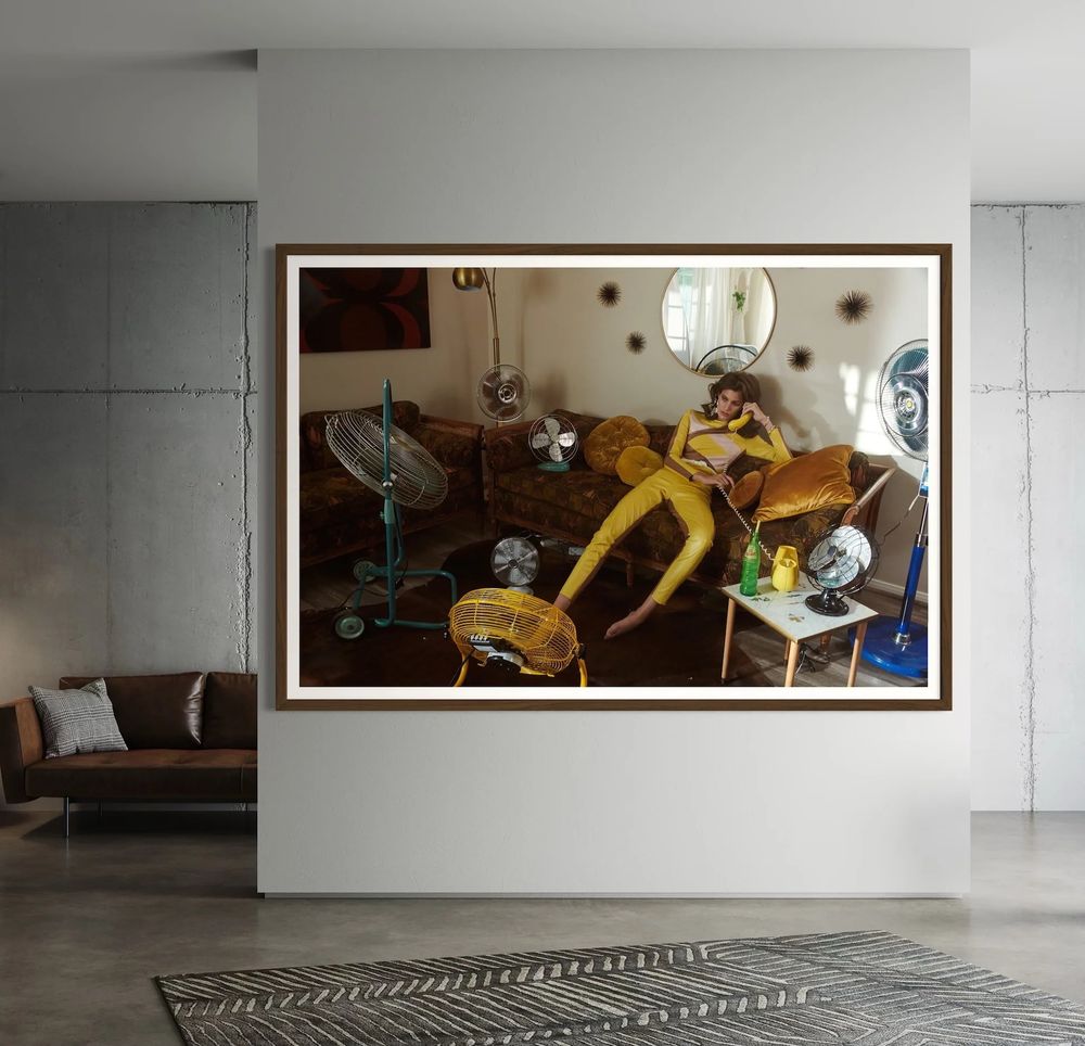 See It On Your Wall

"Cool Your Jets" by Jamie Nelson, 2019

Series: Heatwave

Arty-Fact: In Heatwave, Jamie transforms the desert into a surreal stage where fashion, humour, and climate crisis collide. Set against the iconic Joshua Tree landscape, the series plays with extremes—heat and cold, glamour and desolation, absurdity and urgency. Models lick ice, pose with fans, or bury their heads in freezers—performing the act of cooling in a world that's burning.

Known for her bold colour and playful exaggeration, Jamie dazzles the viewer while subtly confronting them with the realities of climate change. Beneath the pop visuals lies a sharp critique: of our fragile environment, of beauty’s persistence under pressure, and of the absurdity of trying to stay cool as the planet heats up.