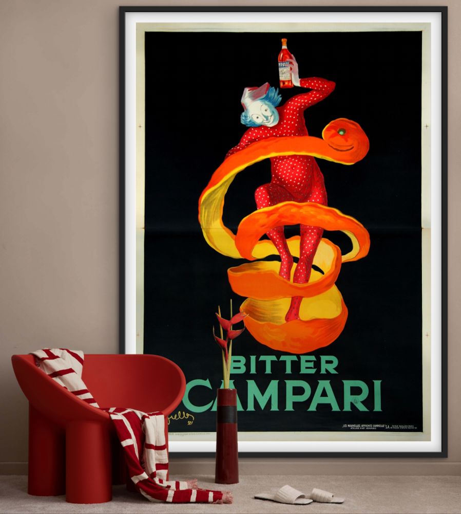See It On Your Wall

"Bitter Campari" by Leonetto Cappiello, 1921

Arty-Fact: Steeped in theatrical tradition from his years as a stage caricaturist, Cappiello often chose pierrots, harlequins or clowns to represent various products. Here, in one of his most inspired designs, the clown embodies the spirit of the orange peel, a zesty ingredient in the Bitter Campari. The image has become one of the classics of poster design, effortlessly combining the elements of surprise with the essence of the product.

The story of this world-famous brand name started in 1860 in the little Italian town of Novara, where Gaspare Campari opened his small wine shop. Within two years, he earned enough to open a cafe on a busy street corner in Milan. Annoyed that his competitors were able to sell everything that he did, he determined to produce his own distinctive liqueur in order to serve something unique. To this end, he developed a recipe for a type of bitters and made a sample batch.

His timing was impeccable: bitters - alcoholic potions made from various aromatic herbs with a supposedly salutary effect on the digestive system - were just coming into vogue at the time, and the Campari Bitter was an instant success. The enterprise grew, and by the time of Gaspare's death in 1882, the product was selling throughout the world. His son, Davide (1887 - 1936), expanded the family business even more, and in 1892, added a second successful beverage, Cordial Campari. Nearly every major Italian posterist (Dudovich, Codognato and Nizzoli among others) was asked at one time or another to design posters for this firm. Cappiello himself produced several including the Bitter Campari of 1912.

[Source: “Cappiello – The Posters Of Leonetto Cappiello” by Jack Rennett, 2004]