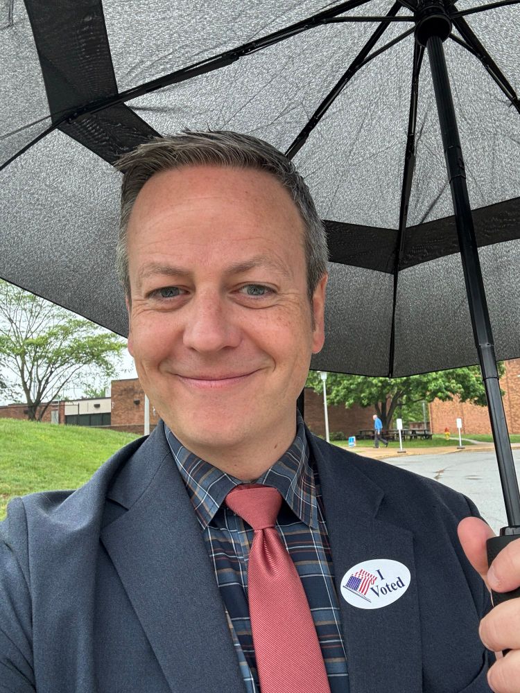 Smiling voter in the rain 
