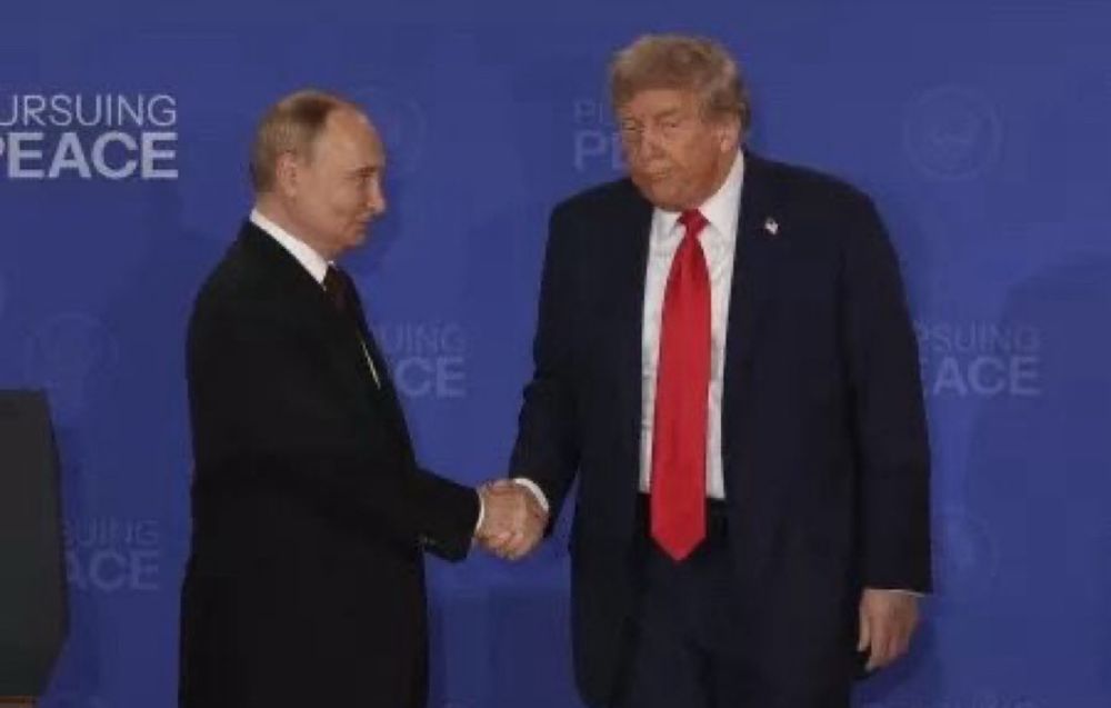 Putin shaking hands with a strange looking Trump at the Alaska Submit