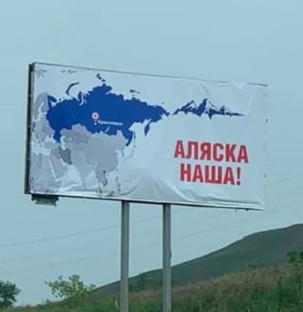 Billboard in Russia showing a map of Russia and adding part of Alaska, with the translation Alaska is ours.