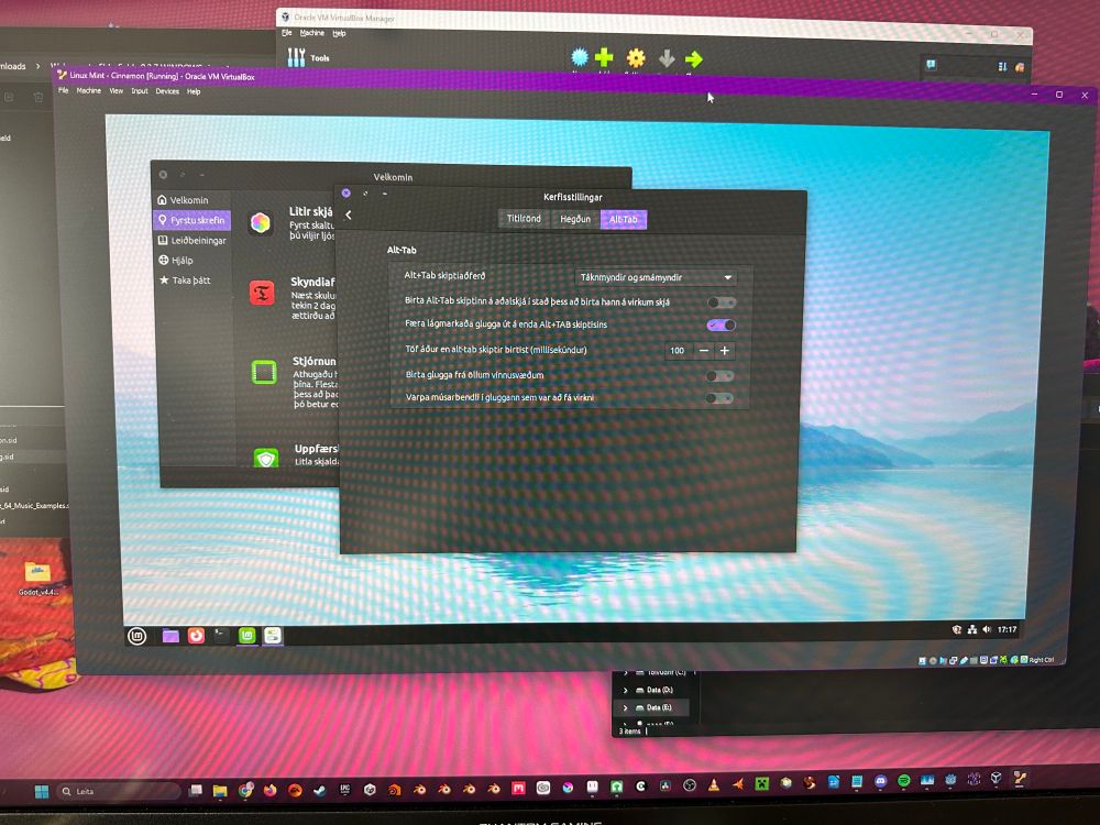 Photo of a screen showing Linux Mint in a virtual box on a windows machine