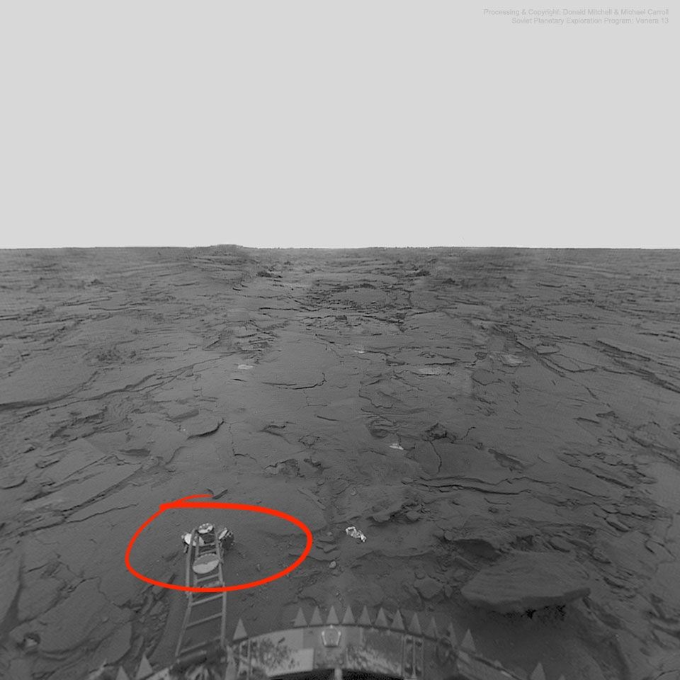 Venera 14 lander view of the surface of Venus. The Venera 14 soil density probe arm is extended and the soil density probe is measuring the density of the ejected Venera 14 lens cap (circled).