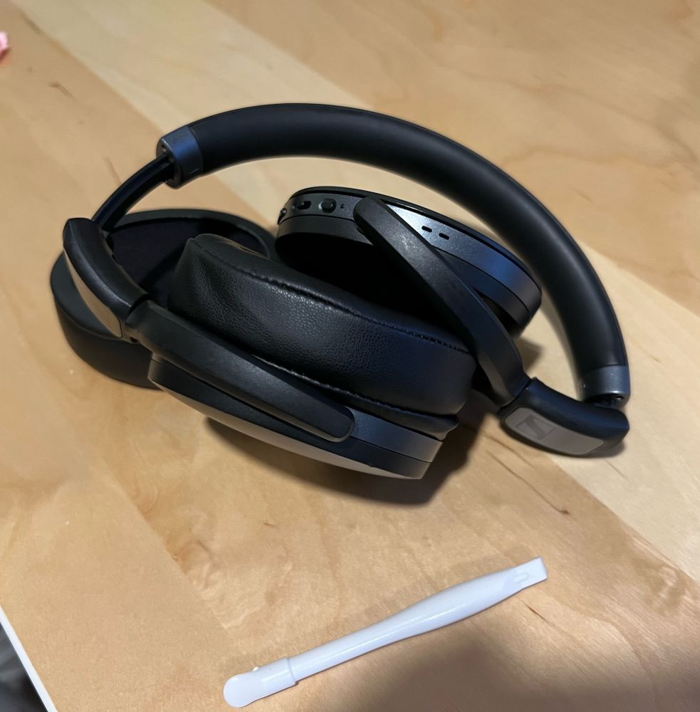 Old headphones with uninstalled ear pads waiting to be broken or repaired.