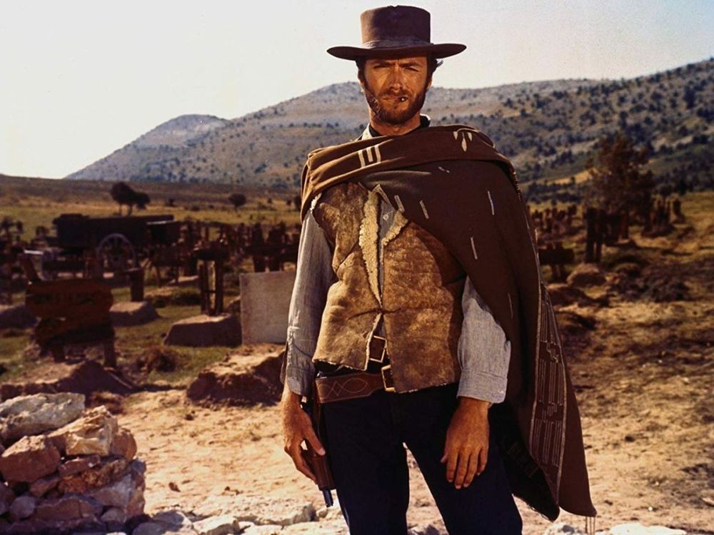 The Still from classic Western film, "The Good, the Bad, and the Ugly," showing Clint Eastwood, hip cocked nonchalantly, staring into the camera.
