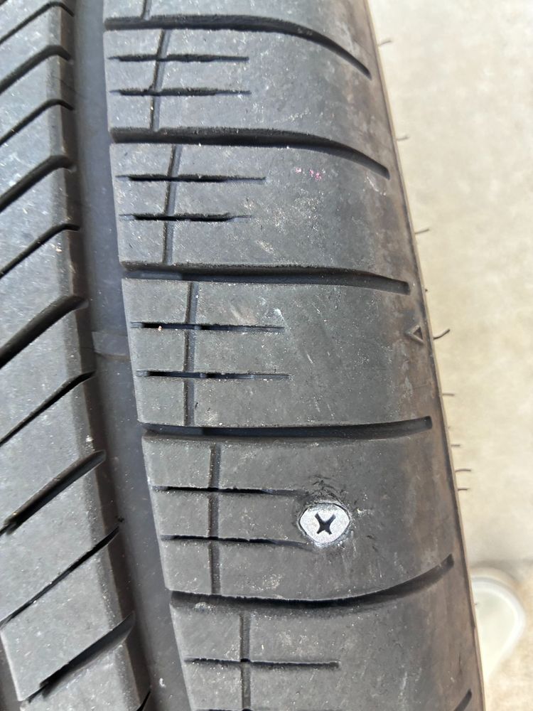photo of a brand new tire with a deep puncture (screw)