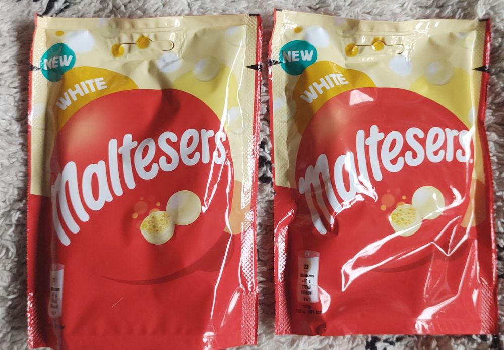 Two bags of white maltesers.