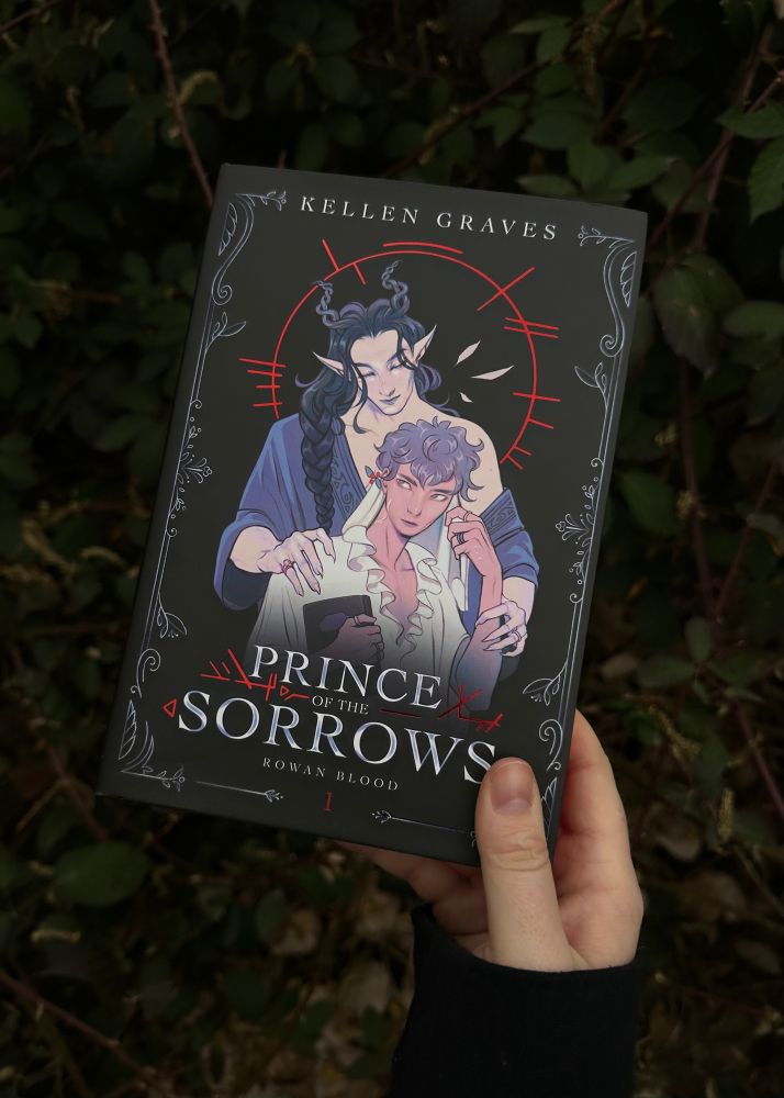Hand displaying front cover of the special edition of POTS