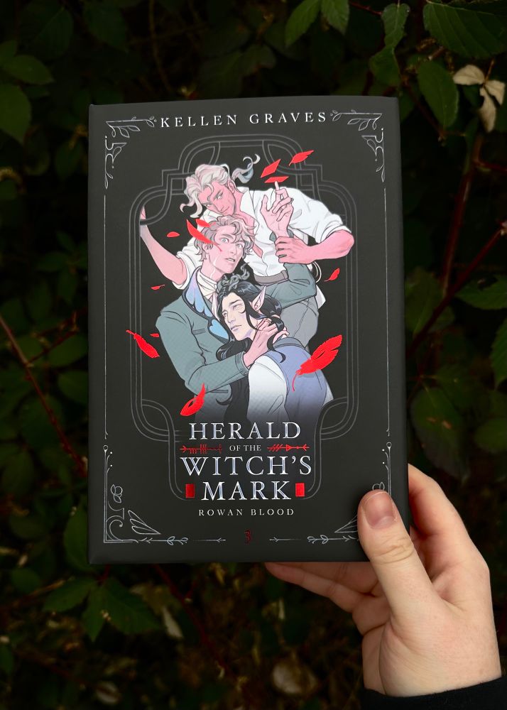Hand displaying front cover of the special edition of HOWM