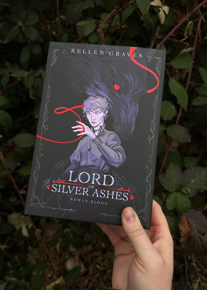 Hand displaying front cover of the special edition of LOSA