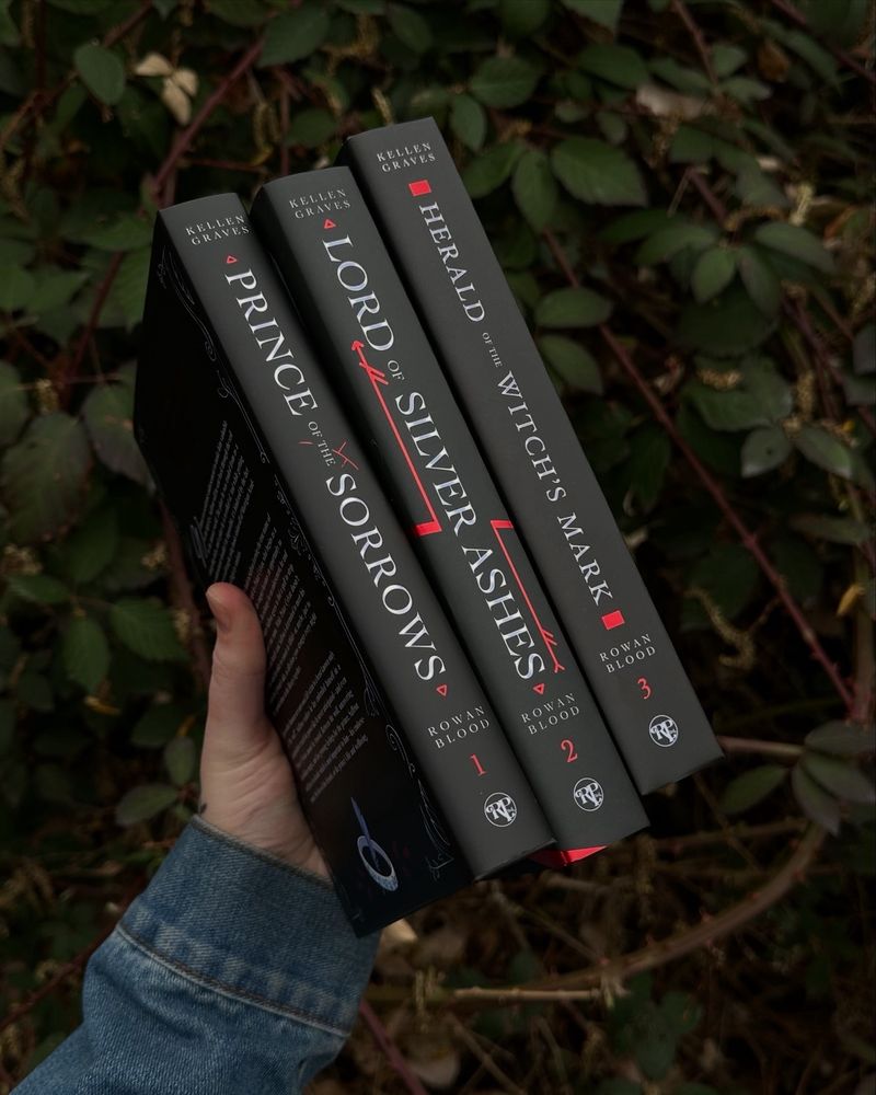 Hand holding special editions of POTS, LOSA, HOWM