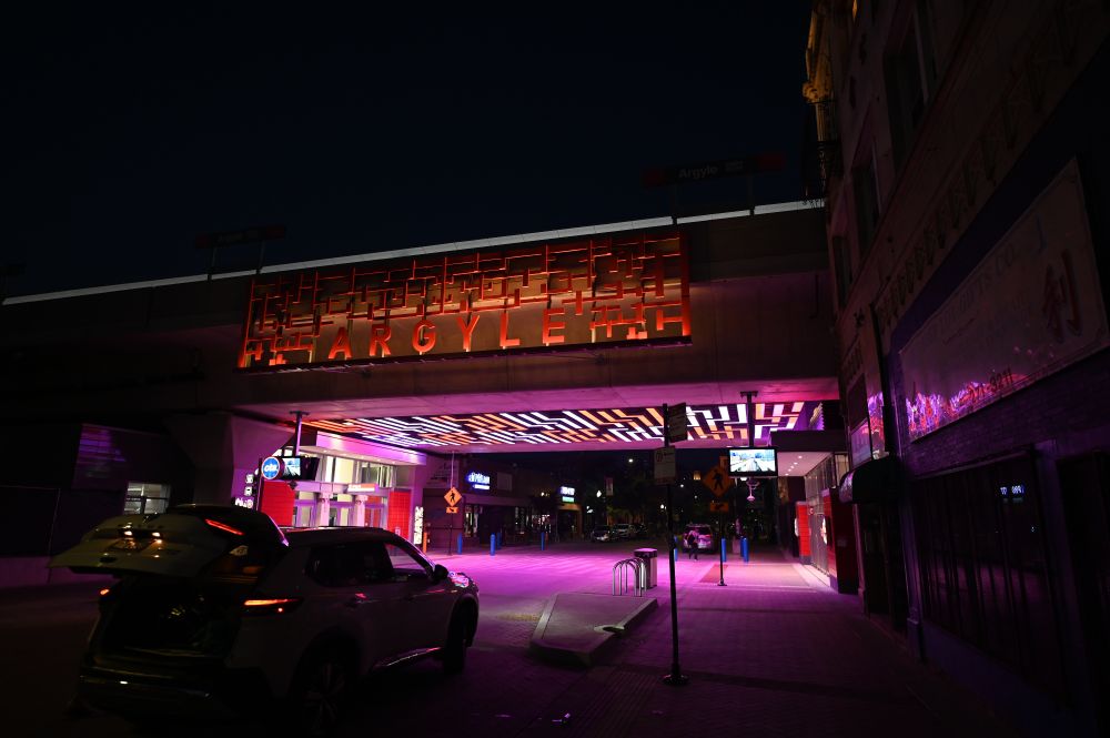 The Argyle CTA station at night, with the Argyle sign illuminated and the station glowing in a variety of colors