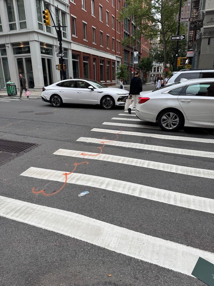 A NYC crosswalk being blocked by cars and a car blocking an intersection after a failed depth perception and timing test. Three different offenses create an unsafe environment for pedestrians yet are seen as allowable acts in the face of a criminal crackdown against cyclists for low level offenses.