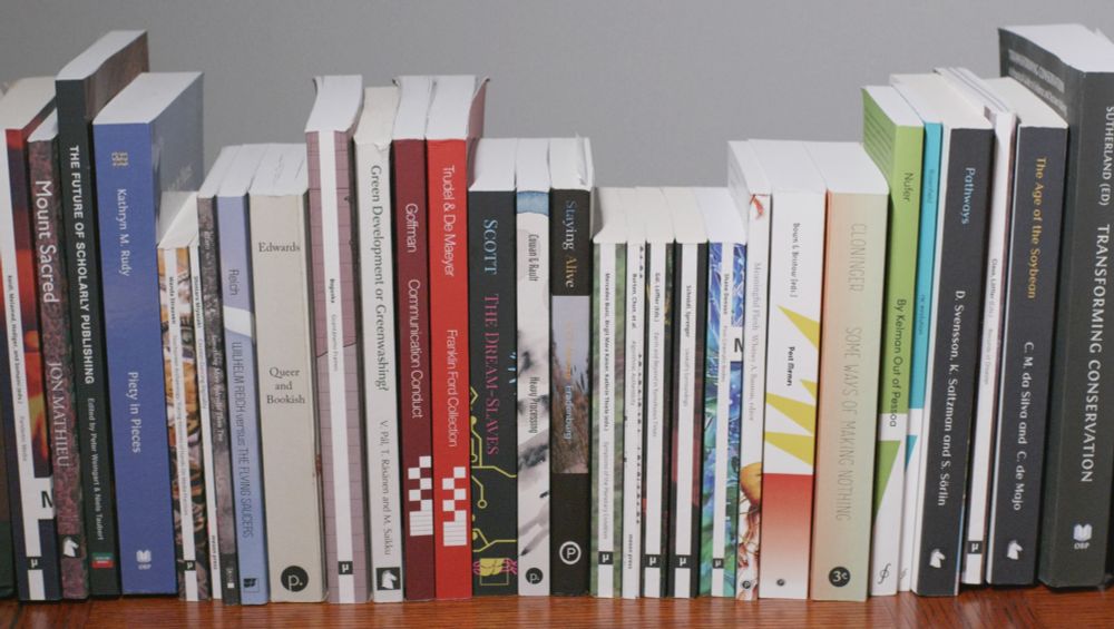 Around 16 books on a shelf of different heights, with multicoloured spines facing outwards