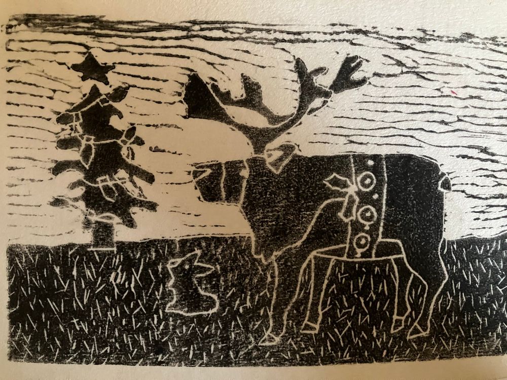 Linoleum block Christmas card featuring a bunny, a deer and a Christmas tree with lights
