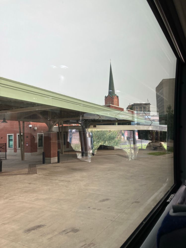 Bus depot with a steeple in the distance 